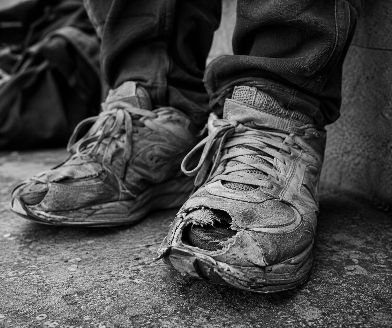 Illustrative reference showing worn, torn sneakers